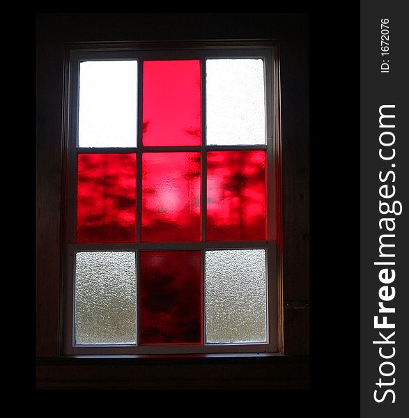 Red stained glass window in a church