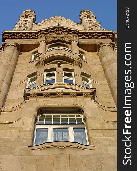 The facade of a tower on the Gresham Palace in Budapest at sunset