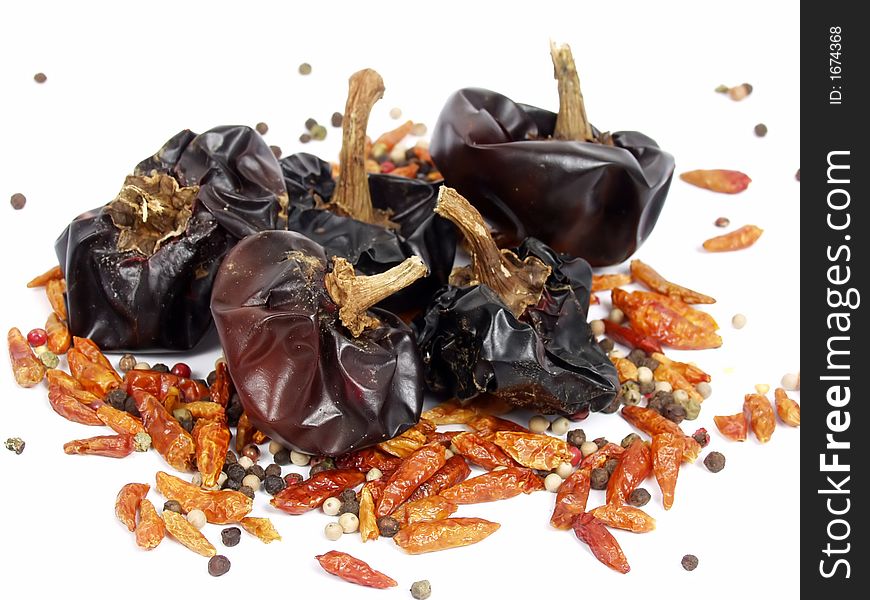 Cayena, bell dry pepper and ground pepper on white background