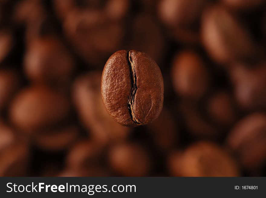 Coffee-bean above coffee grains, horizontal. Coffee-bean above coffee grains, horizontal