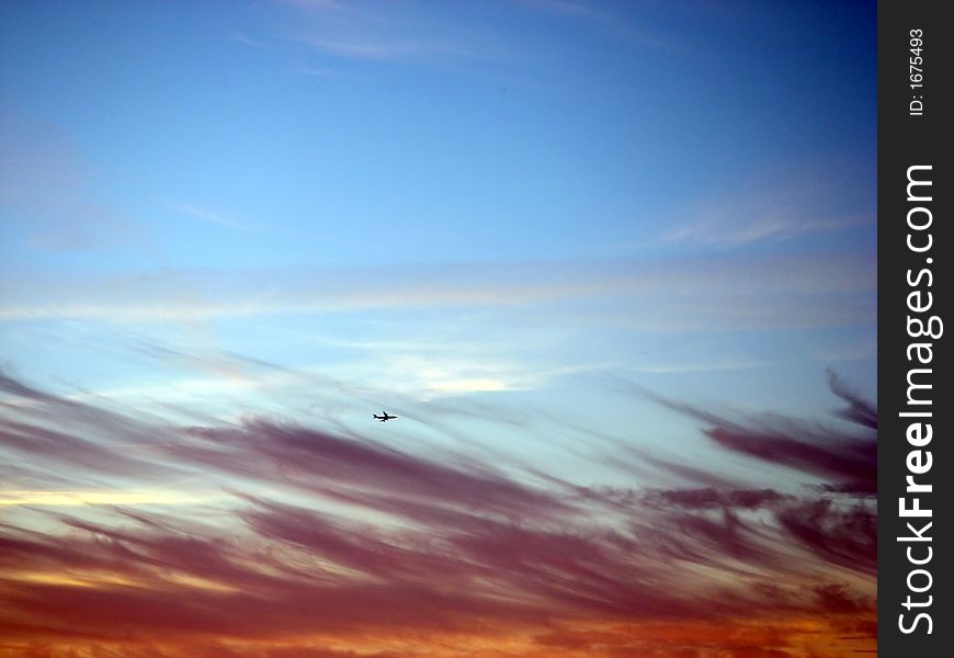 Sky with dramatic colors and airline plane. Sky with dramatic colors and airline plane