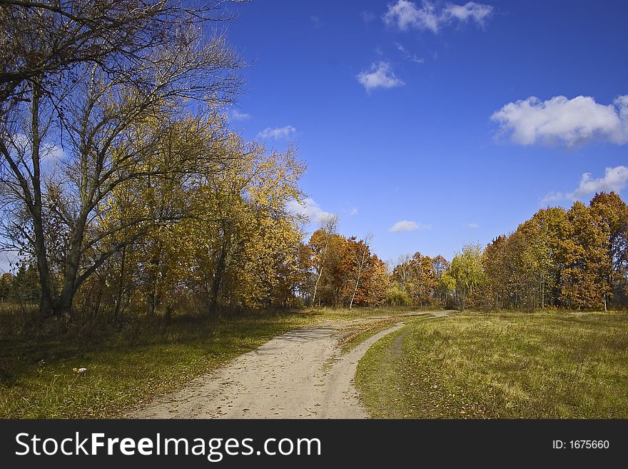 Fall of the leaves, dirt road and beautiful autumn sky. Fall of the leaves, dirt road and beautiful autumn sky