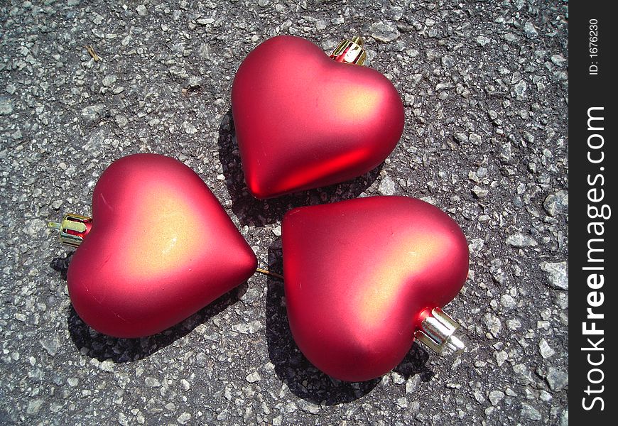Closeup of three hearts made of christmas decoration symbolising friendship