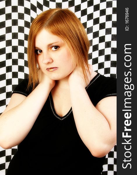 Teen girl against black and white checkered background. Teen girl against black and white checkered background.
