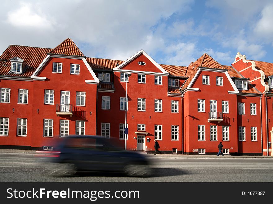 Traffic , cars   speeding in front of an old red building / house (low shutter speed). Traffic , cars   speeding in front of an old red building / house (low shutter speed)