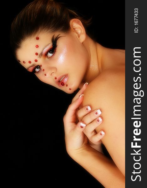 Beautiful young woman in artistic make-up and beads. Beautiful young woman in artistic make-up and beads.