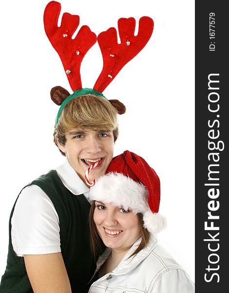 Adorable teen couple in Christmas hats. Casual Christmas.