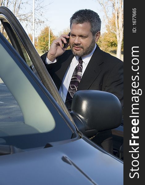 Business man on cellphone in car. Business man on cellphone in car.