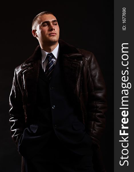 Young Modern Businessman portrait shot in studio over black background