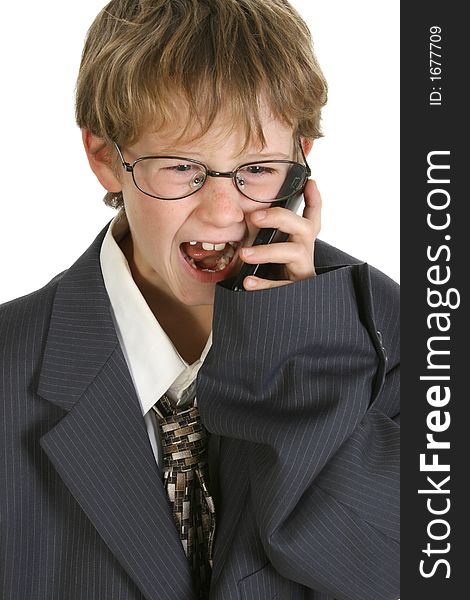 Adorable eight year old boy in father's business suit yelling into cellphone. Adorable eight year old boy in father's business suit yelling into cellphone.