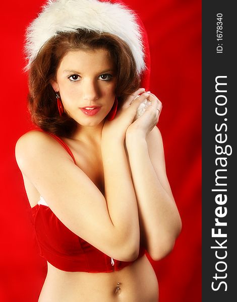 Beautiful teen girl in santa hat and red halter. Beautiful teen girl in santa hat and red halter.