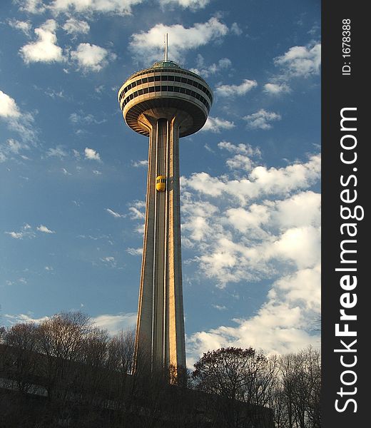 Skylon Tower in Niagara Falls with blue sky and cloud backdrop. Skylon Tower in Niagara Falls with blue sky and cloud backdrop