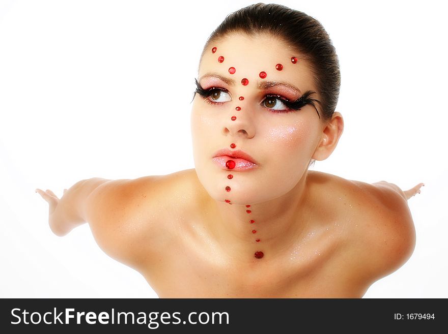 Beautiful young woman in artistic make-up, beads and feathers. Arms out behind her as if to fly. Beautiful young woman in artistic make-up, beads and feathers. Arms out behind her as if to fly.