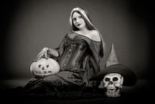 Halloween Witch With A Skull And Pumpkin Royalty Free Stock Photography