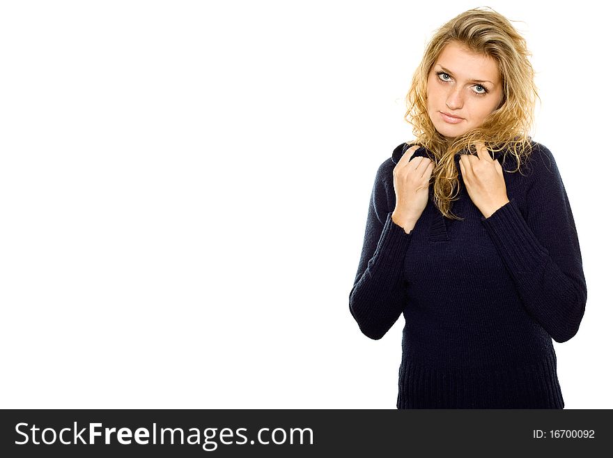 Casual young woman in a blue sweater warms. Isolated on white background