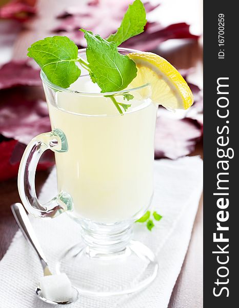 Hot lemon tea in glass with mint