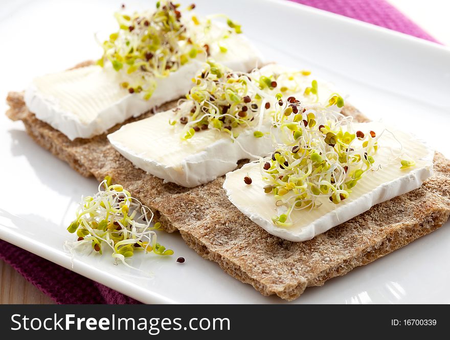 Crispbread with soft cheese and sprouts. Crispbread with soft cheese and sprouts