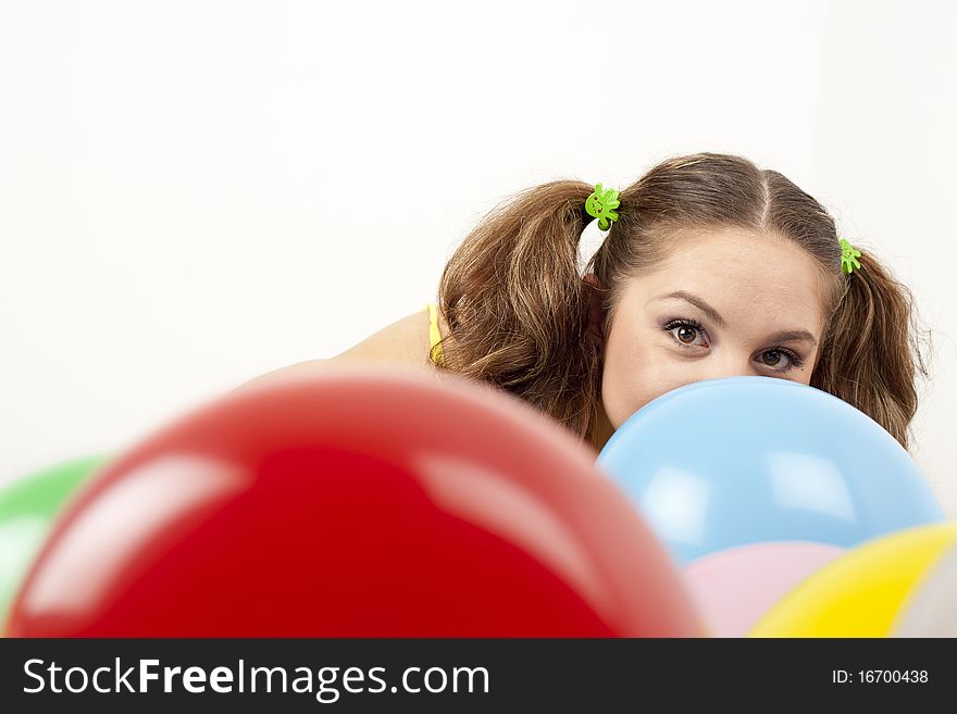 Young woman having fun playing with baloons