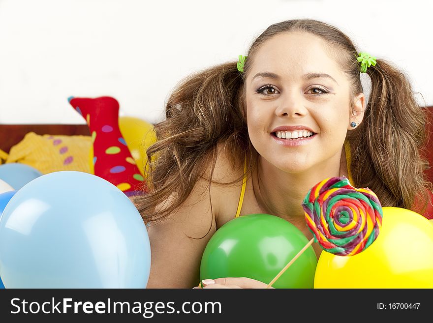 Young woman having fun playing with baloons