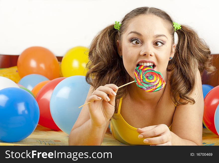 Young woman having fun playing with baloons and goofing around