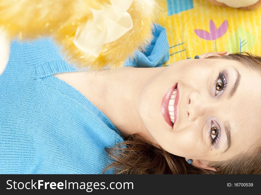 Young woman having fun playing with dolls