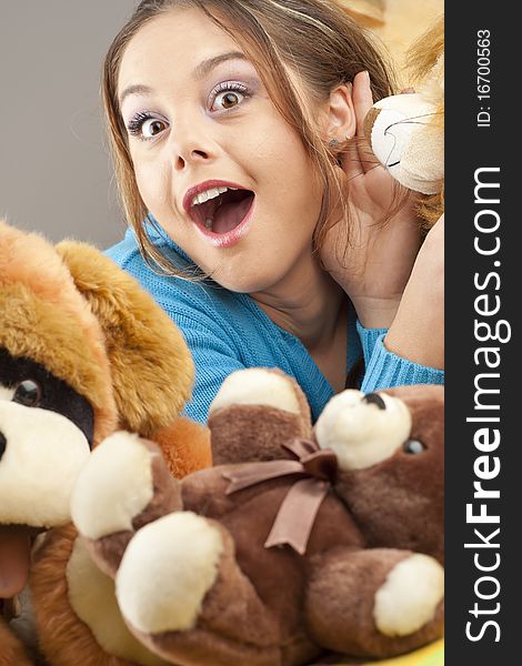 Young woman having fun playing with dolls