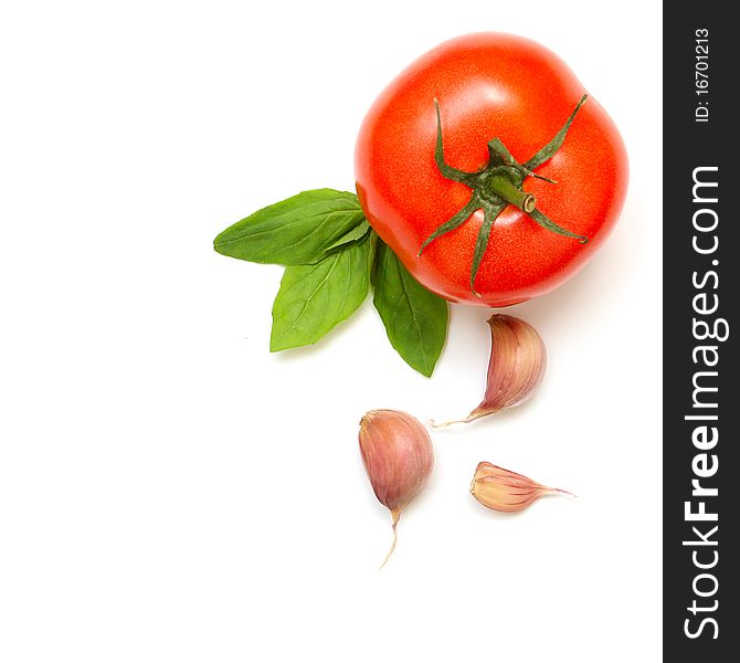 Fresh tomatoes, basil and garlic isolated on white background