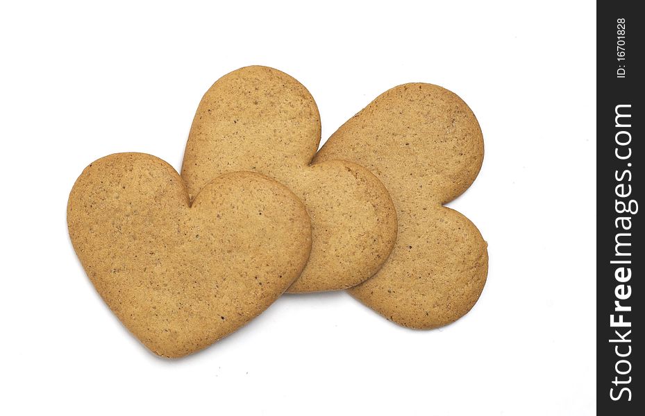 Three heart shaped cookies on white background. Christmas feeling. Three heart shaped cookies on white background. Christmas feeling.