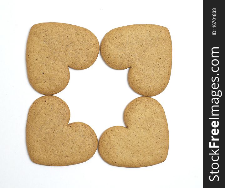 Four heart shaped cookies on white background. Christmas feeling. Four heart shaped cookies on white background. Christmas feeling.