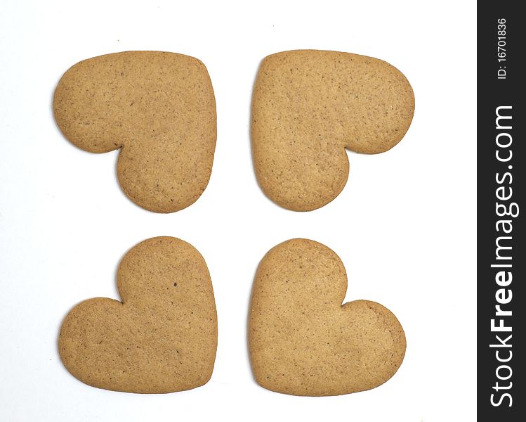 Four heart shaped cookies on white background. Christmas feeling. Four heart shaped cookies on white background. Christmas feeling.