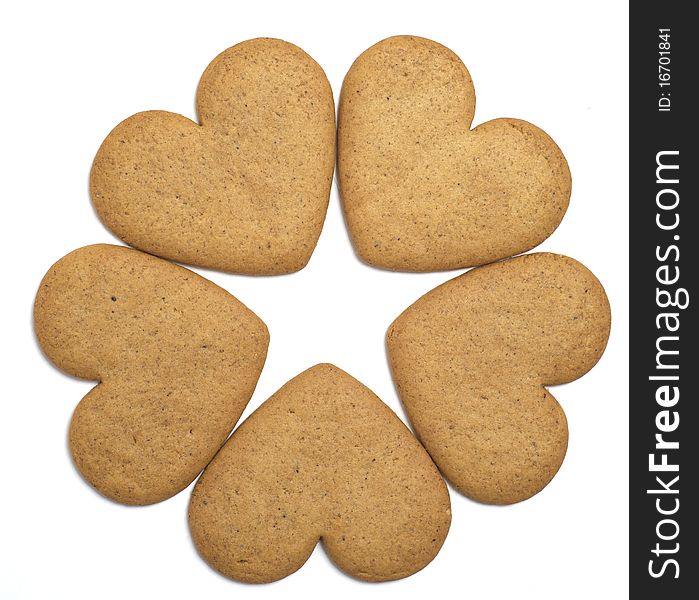 Five heart shaped cookies on white background. Negative space forms a star. Christmas feeling. Five heart shaped cookies on white background. Negative space forms a star. Christmas feeling.