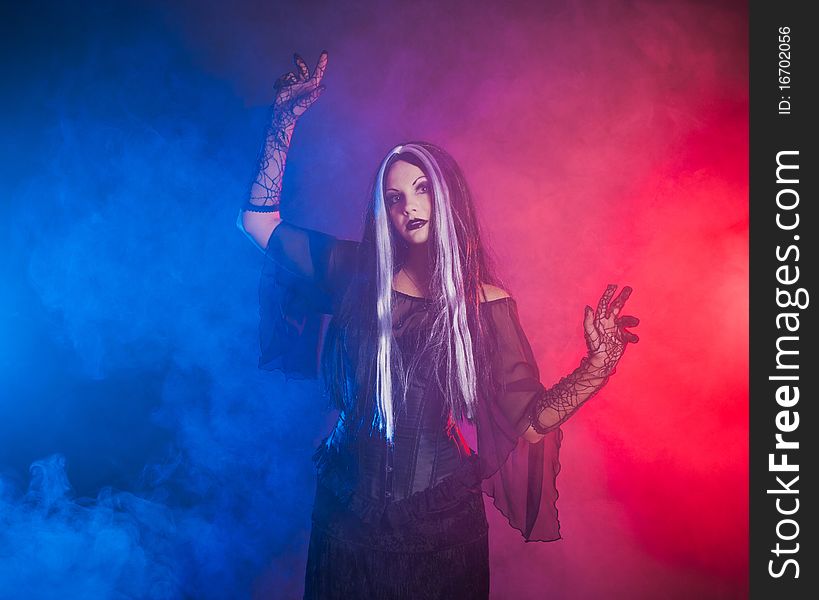 Gothic girl on red-blue smoke background