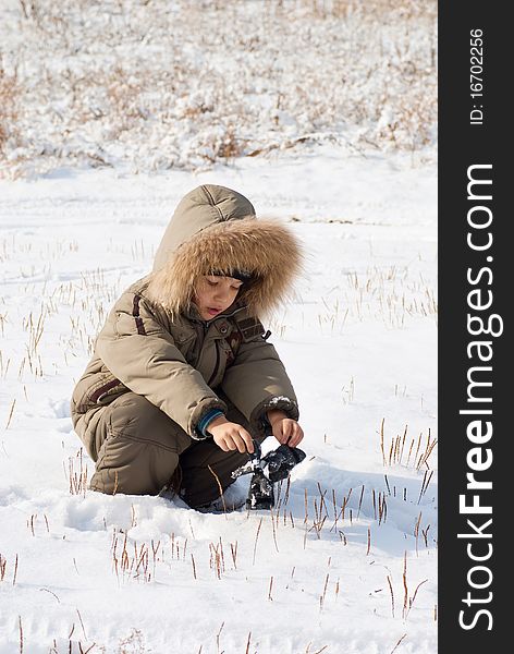 Little boy standing in the snow