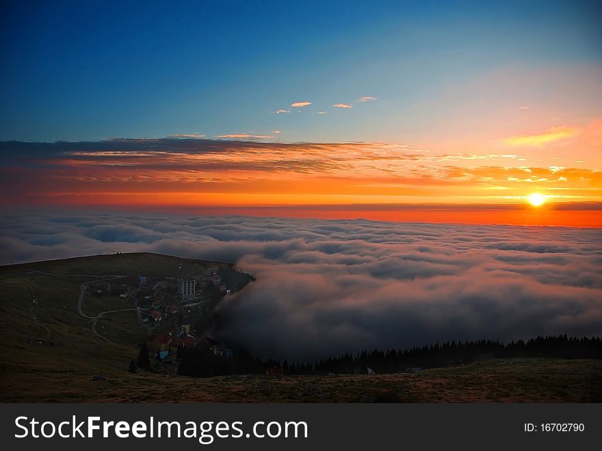 Sunset over clouds from mountain top
