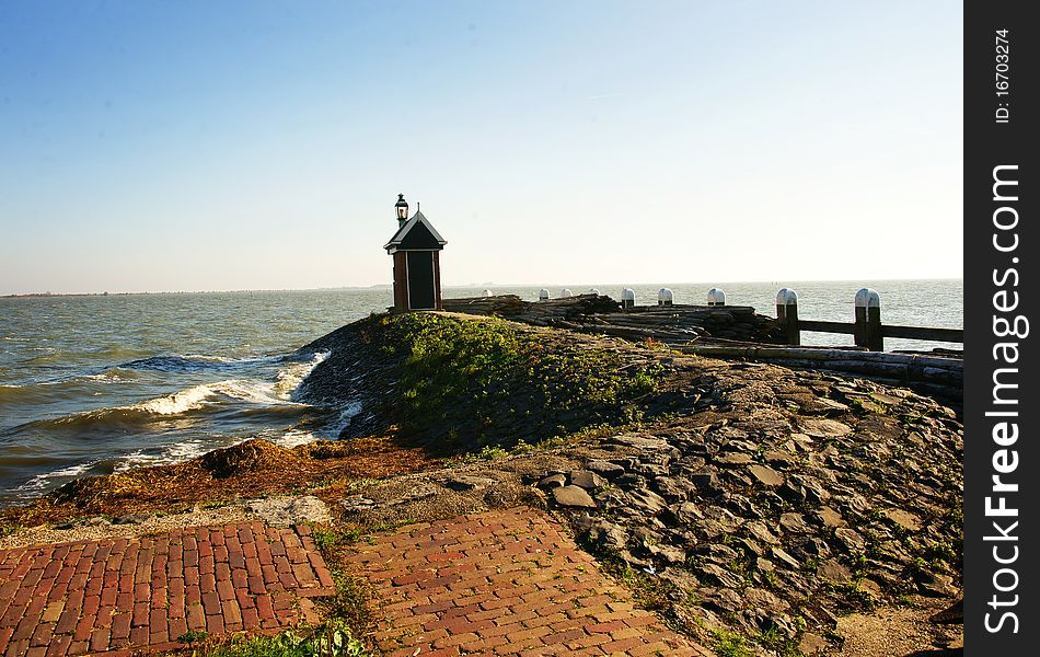 Lighthouse pier with brick walk street facing sea