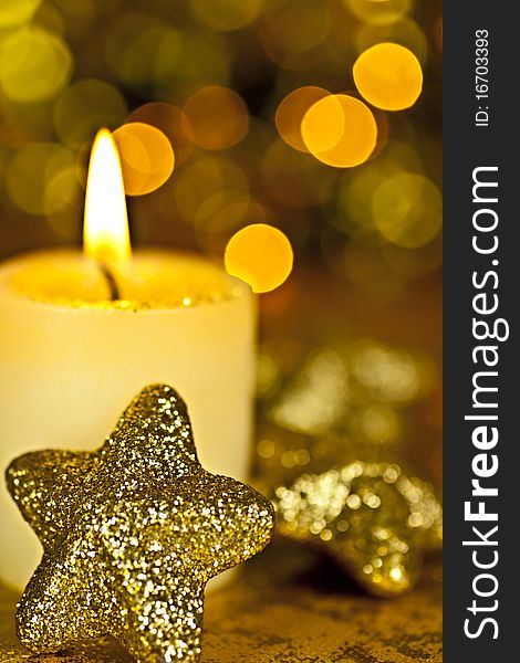 Candle with a star on a black background, back background Bokeh lights. Candle with a star on a black background, back background Bokeh lights.