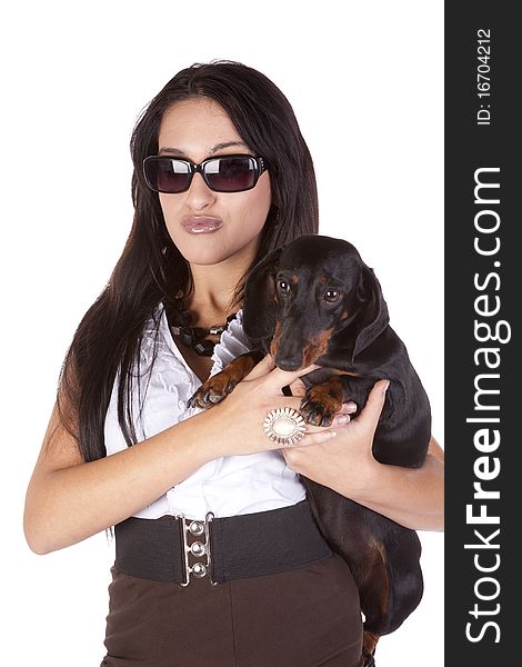 A woman is holding a dog and the woman is wearing sunglasses. A woman is holding a dog and the woman is wearing sunglasses.