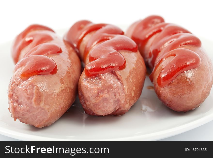 Sausages on a plate on a white background