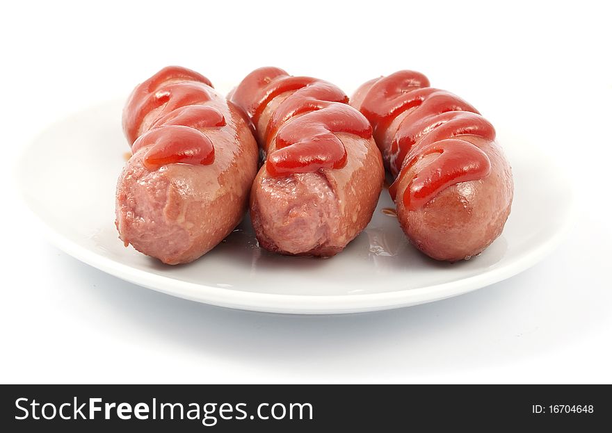 Sausages on a plate on a white background