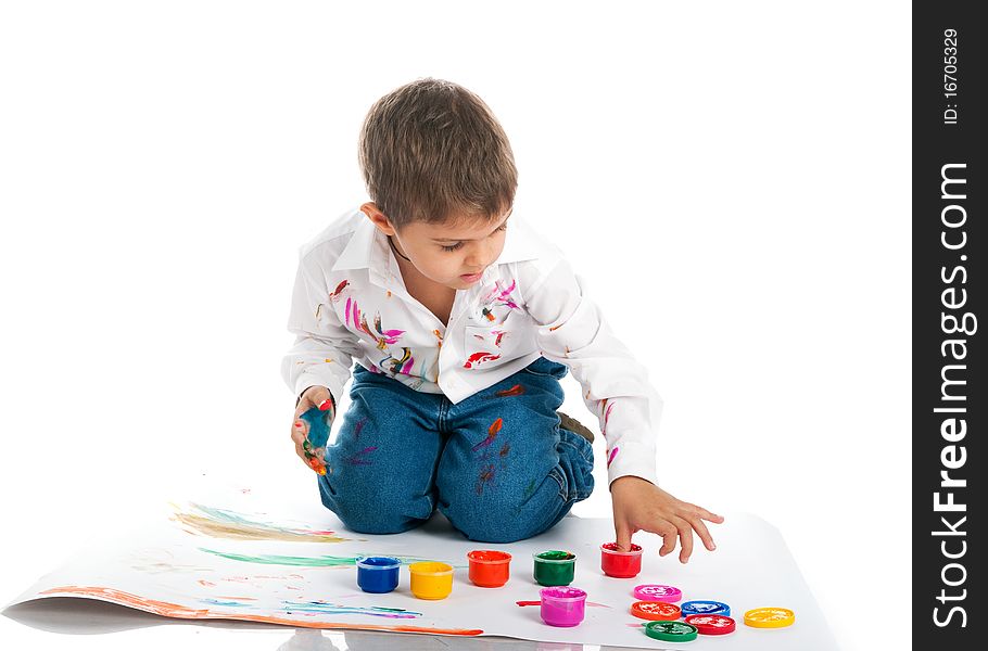 Cute little boy covered in bright paint