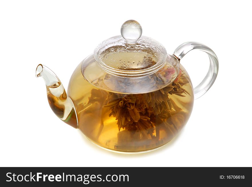 Glass teapot with blooming flower green tea on white background