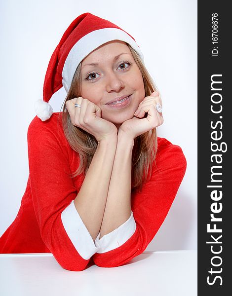 Beautiful young smiling girl in Santa red hat