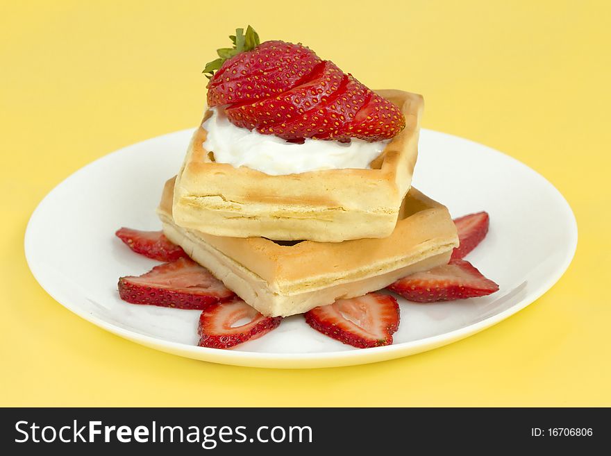 Belgian waffles with strawberries and whipped cream. studio lights and 100mm macro lens. Belgian waffles with strawberries and whipped cream. studio lights and 100mm macro lens.