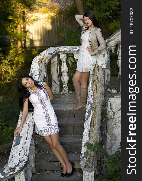 Two female friends standing on stairs