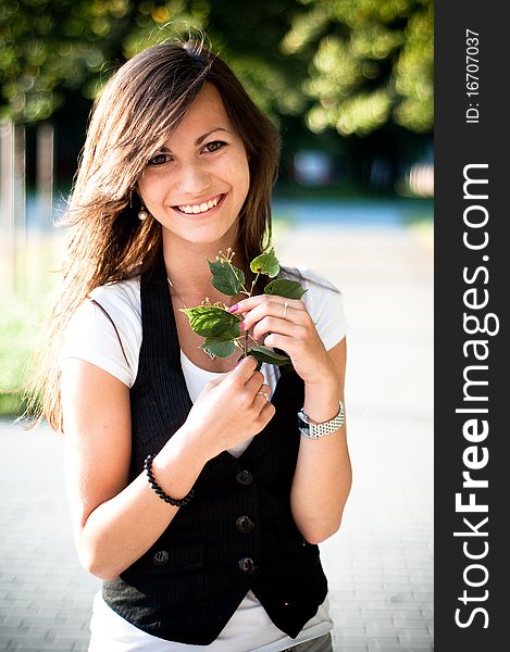 Young smiling girl with linden blossom. Young smiling girl with linden blossom