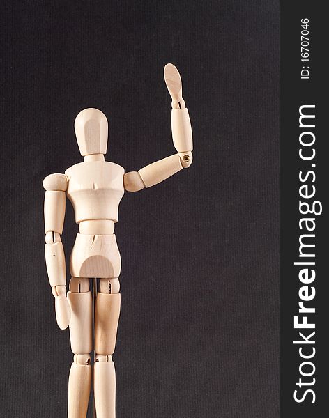 Wooden Doll Waving Hello On Gray