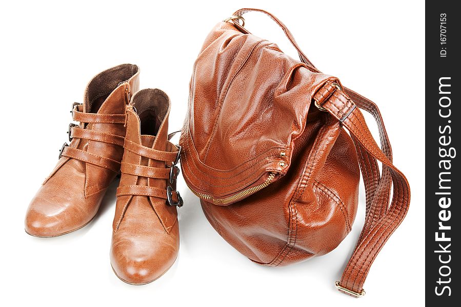 Brown leather bag and pair feminine boots on white background