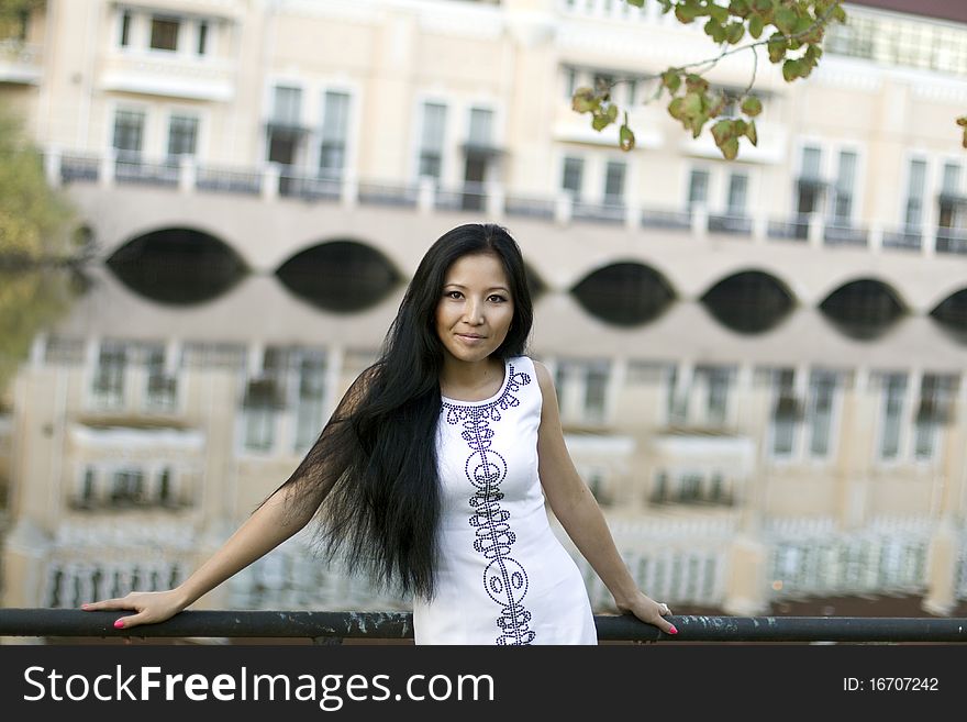 Girl walking near river in park