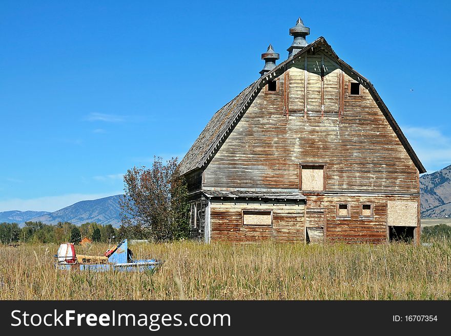 Old Abandoned Barn With Broken Snowmobile