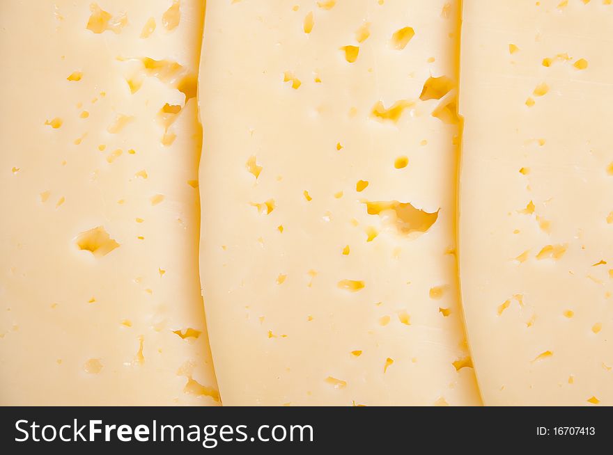 Cheese with many holes abstract background, close-up. Cheese with many holes abstract background, close-up